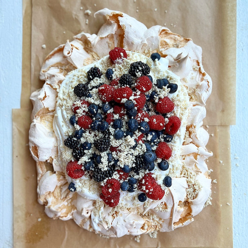Tahini Swirl Pavlova with Cream, Berries & Snowy Halva Flakes