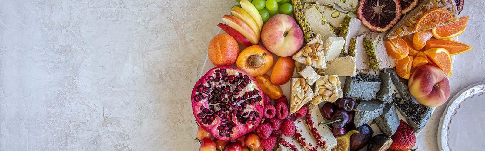 A halva board covered in colorful fruit.