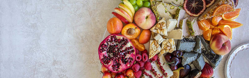 A halva board covered in colorful fruit.