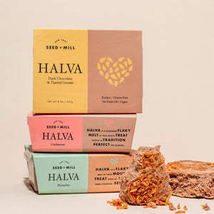 An image of three stacked halva containers with crumbled halva on the side.