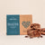 A box of sea salt dark chocolate halva with crumbled halva on the side.