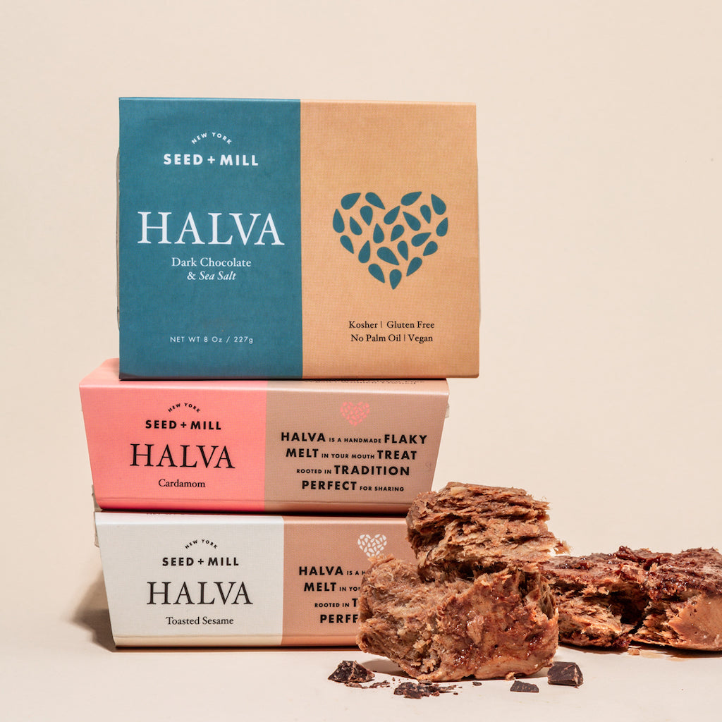 An image of three stacked halva containers with crumbled halva on the side.